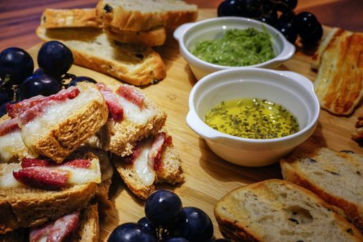 Red wine and appetizers on wooden background