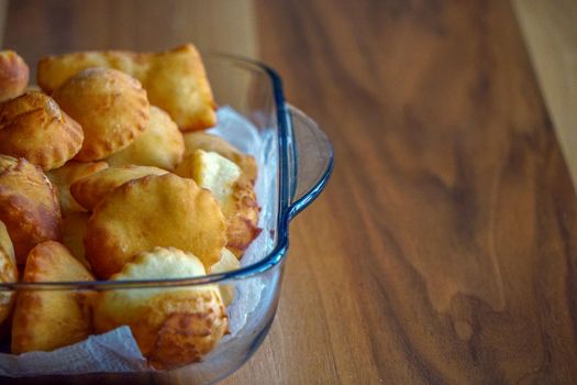 Leavened dough pastry on glass dish on wooden background with copyspace Turkish breakfast concept