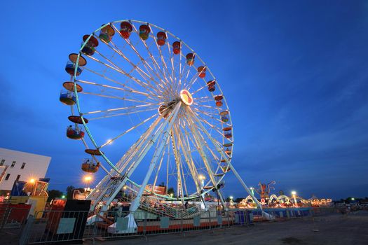 Ferris Wheel at amusement park at twilight time