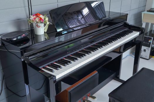 A black electronic piano with piano keys