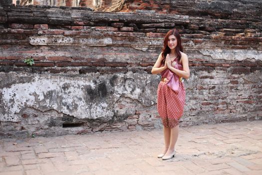 Female pay respect in Thai traditional dress at  historical park