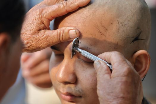 Male who will be monk shaving hair for be Ordained to new monk