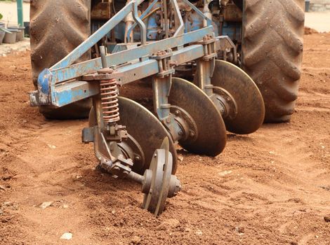 Close-up Tractor plow on red  soil, Thailand