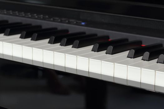 close-up of piano keys of black piano