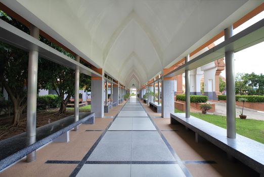 long empty corridor between garden and building 