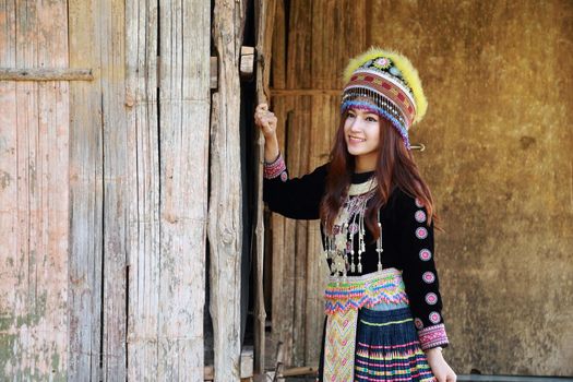 Traditionally dressed Mhong hill tribe woman in the wooden cottage