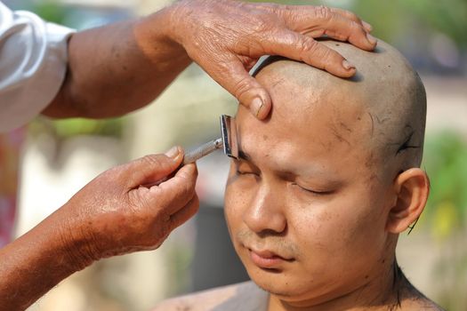 Male who will be monk shaving hair for be Ordained to new monk