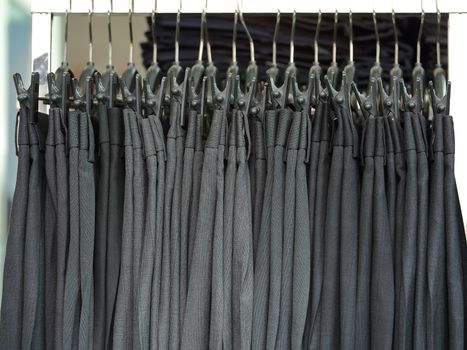 Mens dress pants trousers hanging in a retail shop