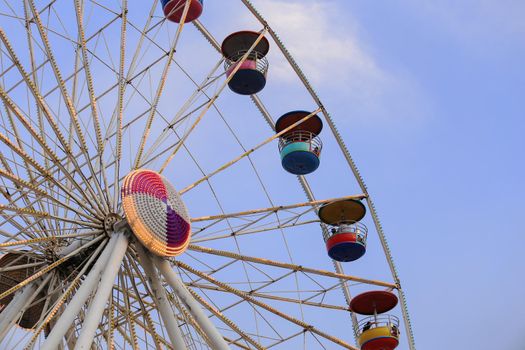 Ferris Wheel at amusement park with blue sky background