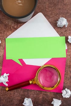 Speech Bubble Letter With Envelope And Magnifying Glass Over Table.