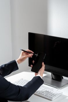 Businesswoman Pointing With Pen On Mobile Phone With Important Message.