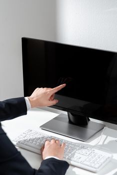 Businesswoman Pointing Important Infortmation With One Finger On Computer.