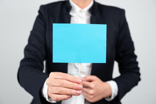 Businesswoman Presenting Important Message On Paper Attached To Stick.