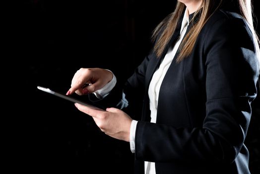 Businesswoman Holding Tablet In One Hand And Pressing On It.