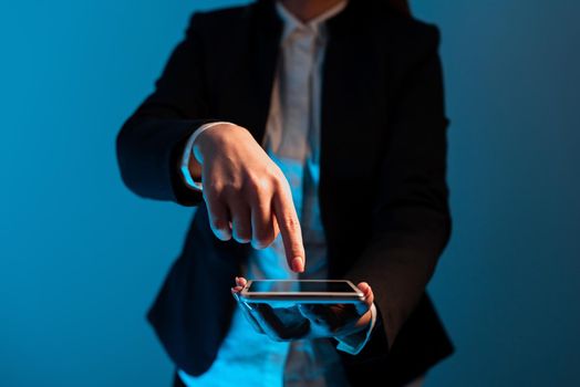 Businesswoman Holding Tablet And Pointing With One Finger On Important News