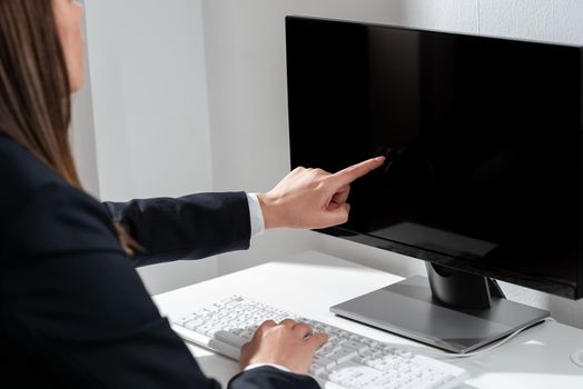 Businesswoman Pointing Important Infortmation With One Finger On Computer.