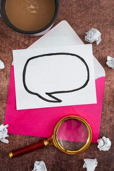 Speech Bubble Letter With Envelope And Magnifying Glass Over Table.