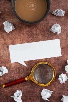 Speech Bubble Sheet With Crumpled Papers, Magnifying Glass And Coffee Cup.