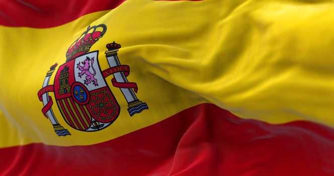 Close-up view of Spain national flag waving in the wind. Spain is a country in southwestern Europe. Fabric background