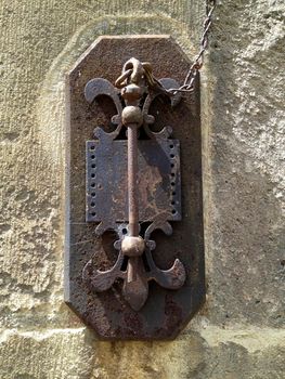 old rusty key hanging on the stone wall