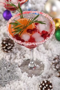 Christmas Cranberry margarita cocktail is mandarin and rosemary combined with cranberries and tequila. This cocktail is bursting with vibrant citrus and herb aromas, showcasing the best winter season fruits.Festive Christmas or New Year drink