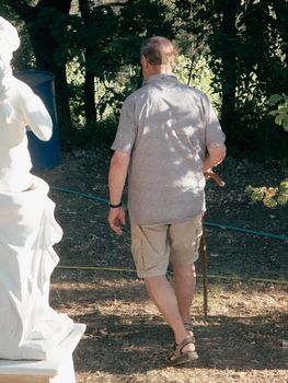 old man with sky pole walking around in garden and farm in summer season