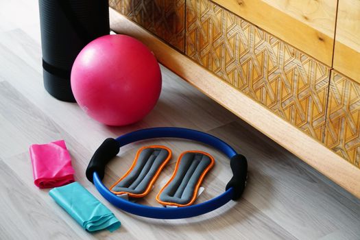 Pilates set with mat stretch ball on wooden background