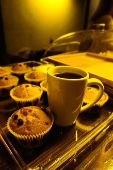 Cup cake and filter coffee close up view