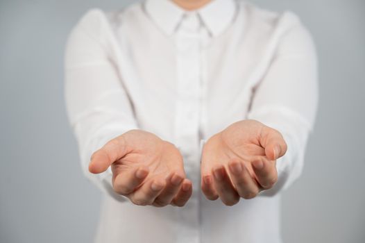 Close-up of caucasian woman holding her palms up