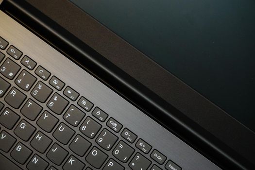 Laptop monitor and keyboard in triangle orientation asymmetric image