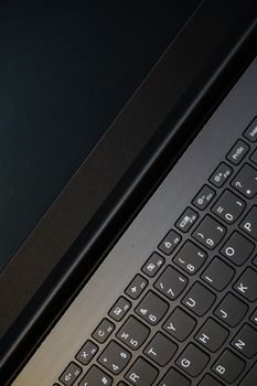 Laptop monitor and keyboard in triangle orientation asymmetric image