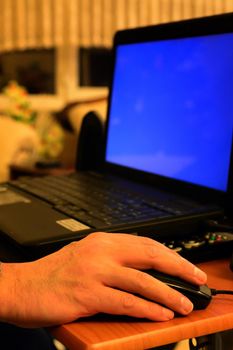 Senior hand using laptop close up view