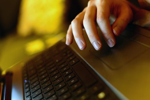 Woman hand on laptop keyboard working at home home office concept