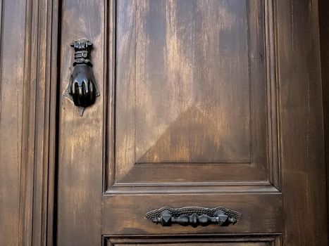 Old wooden door with metal handle ornaments