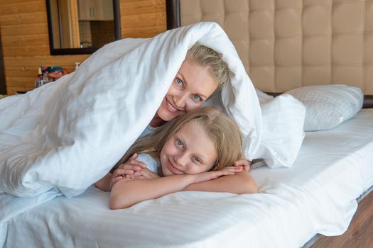 Blanket daughter woman glad over family bed head young mobile, from sleeping white in pillow and person smile, nap bedtime. Beauty relaxation serene,