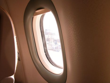Typical airplane window from passenger seat view and dark background for wallpaper dreaming atmosphere concept