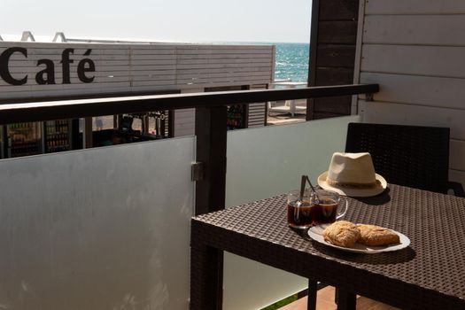 RUSSIA, CRIMEA - JUL 04, 2022: Caf cup sea restaurant coffee buns sky summer background over, from wood life in drink and white espresso, break beverage. Fresh hotel sunrise,