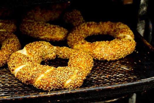 Freshly cooked bagel and dough on industrial tray