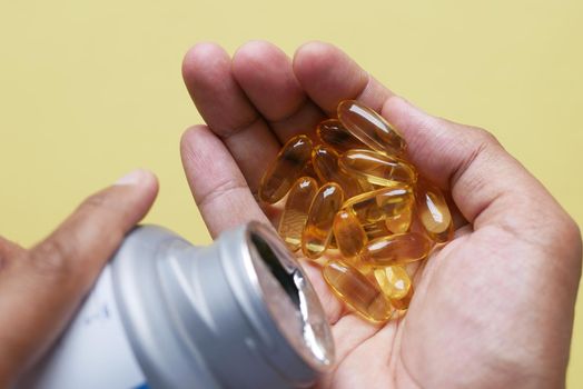 fish oil supplement on hand top view ,