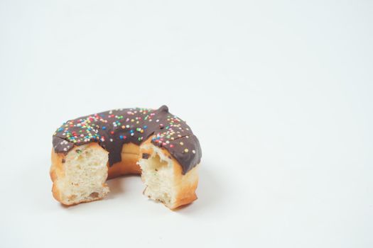half eaten chocolate donuts on white background ,