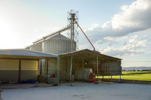 Exterior of Grain silo at sunset on field