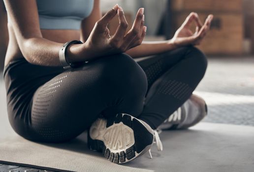 Make your day more zen. Closeup shot of an unrecognisable woman meditating in a gym