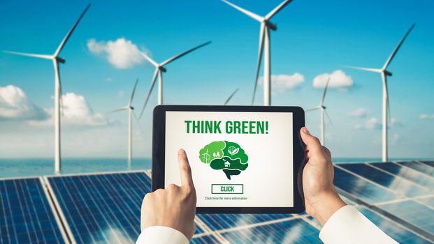 Green business transformation for environment saving and ESG business concept. Businessman using tablet to set corporate goal toward environmental friendly management and alternative clean energy use.