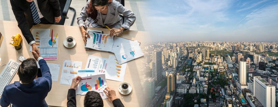 Group business people handshake at meeting table in widen view in office together with confident shot from top view . Young businessman and businesswoman workers express agreement of investment deal.