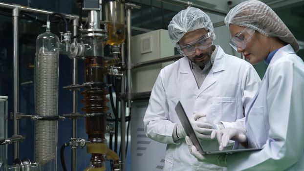 Two scientist in professional uniform working in laboratory for chemical and biomedical experiment