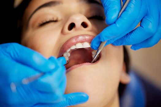 The whole tooth and nothing but the tooth. a young woman having a dental procedure performed on her