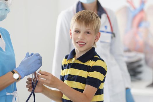 Portrait of boy kid on appointment in clinic, pediatrician going to examine health condition of kid. Health childhood, checkup, medicine, analysis concept