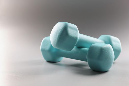 Close-up of pair of blue dumbbells, equipment weight loss, sport activity, physical exercise. Sport, health, physical activity, habit, goal, gym concept