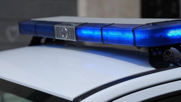 Police lights on car watching traffic on city road. Flashlight on car of ministry of emergency Situations and red blue flashing lights on cars of special forces concept