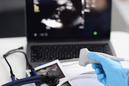 Close-up of medical equipment in clinic, modern ultrasound machine, scanners and sensors. Skillful sonographer at work. Medicine, scanning, health concept